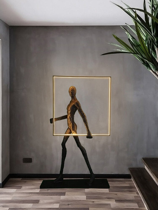 Gold plated art sculpture holding a light up square